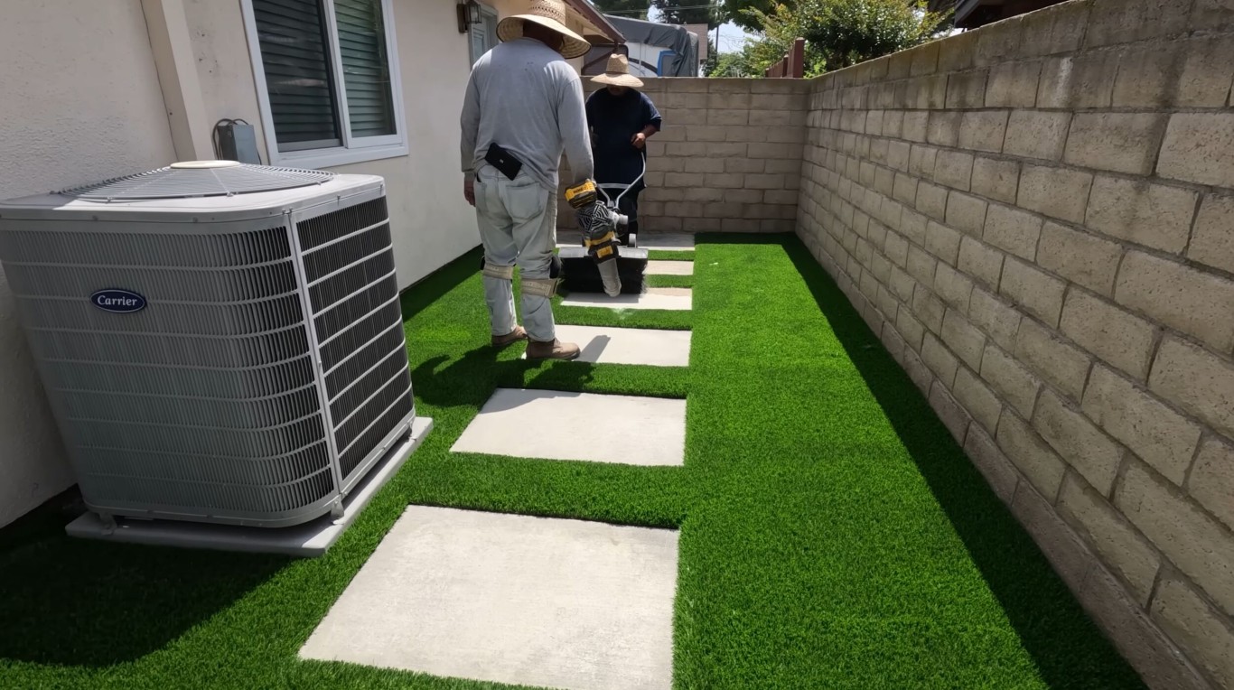 Artificial turf installation with concrete pavers for low-maintenance landscaping in Santa Monica