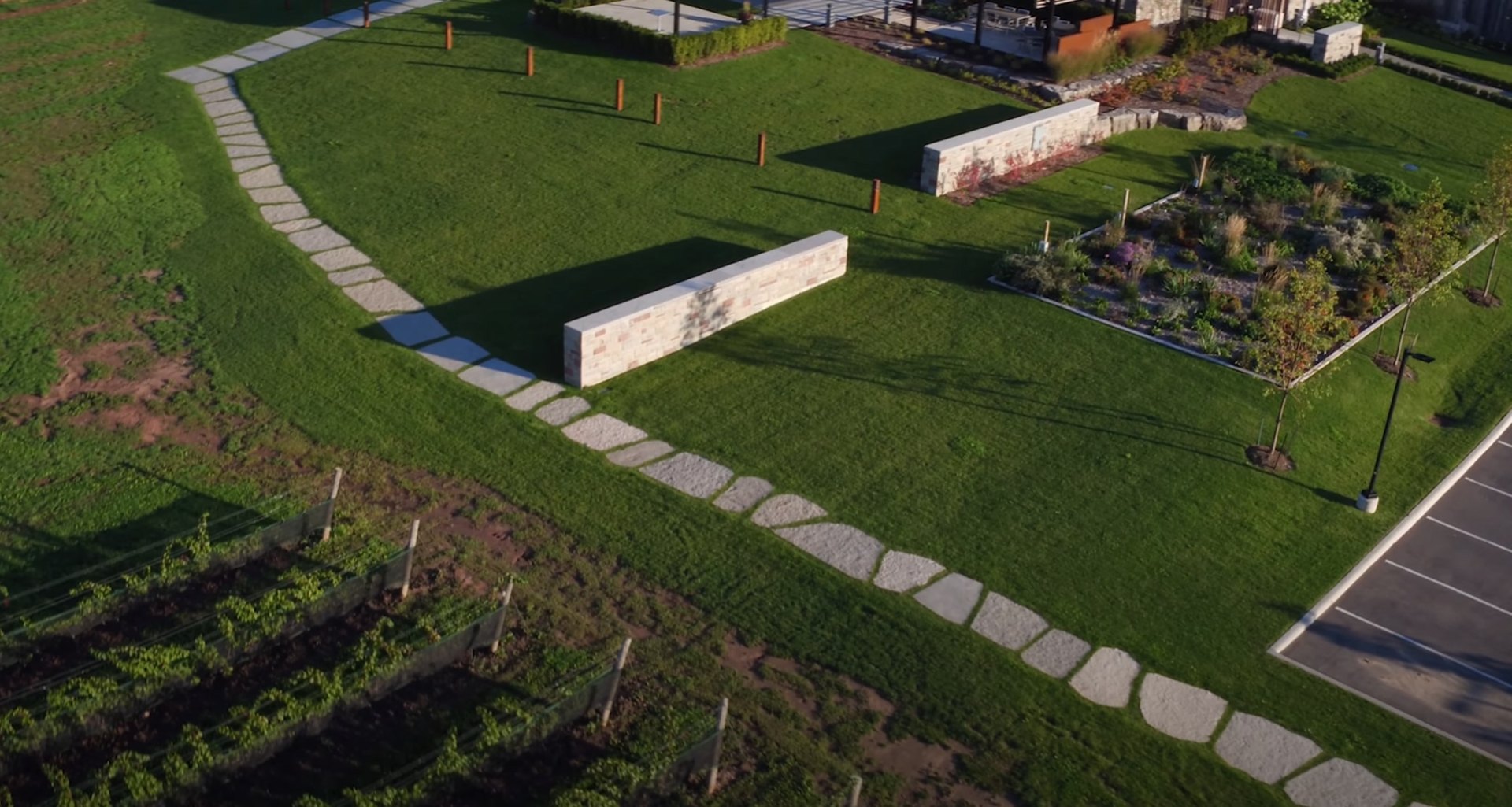 Complete Site Design with Hardscape Elements Aerial landscape view showing stone pathways, retaining walls, and comprehensive site design