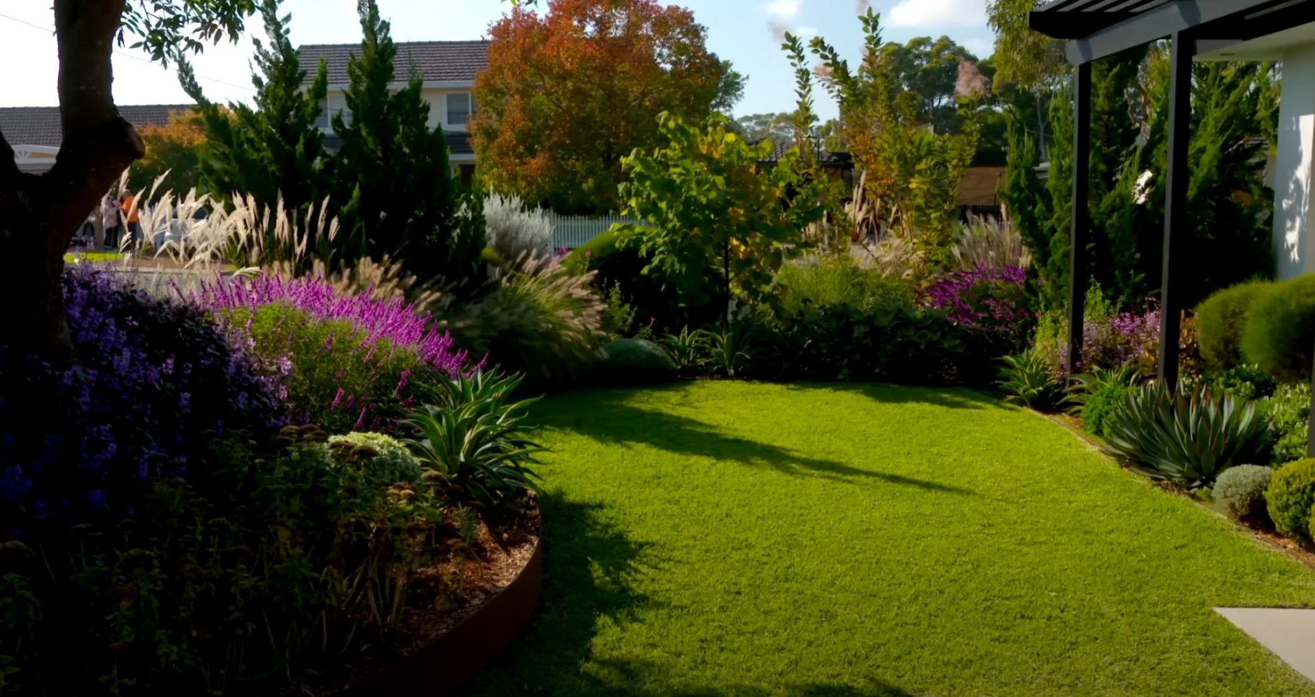 Comprehensive Landscaping Services Santa Monica Beautifully landscaped backyard garden with lush plantings, ornamental grasses, and mature trees